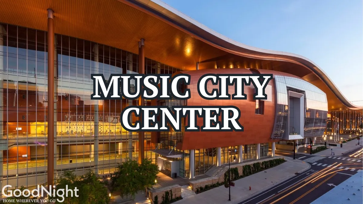 The image captures the striking exterior of the Music City Center, with its modern, curved roofline and grand entrance steps bustling with activity. The vibrant scene suggests a lively urban setting and gives a sense of proximity to major business and event hubs in downtown Nashville.