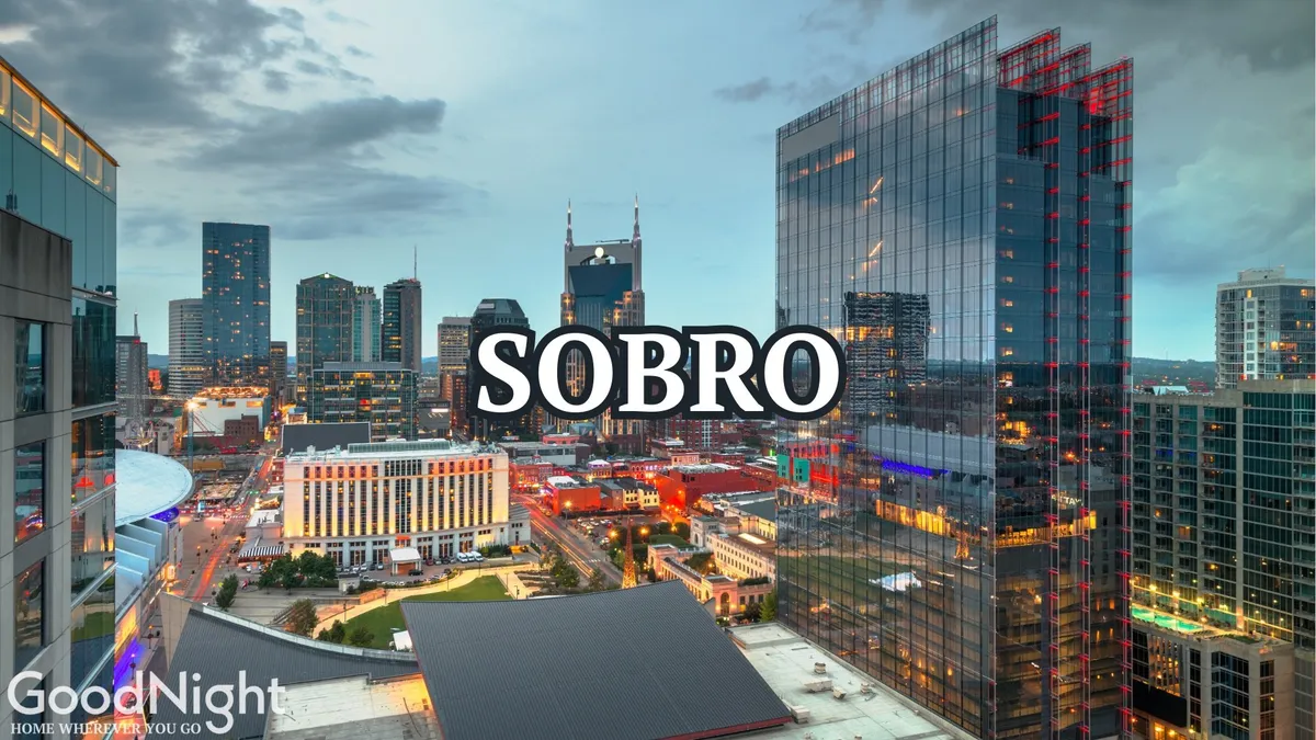 A panoramic view of the Nashville city skyline at night, with buildings aglow and outdoor spaces bustling. The vibrant nightlife and illuminated cityscape showcase the possibilities for dining, music, and urban adventure.